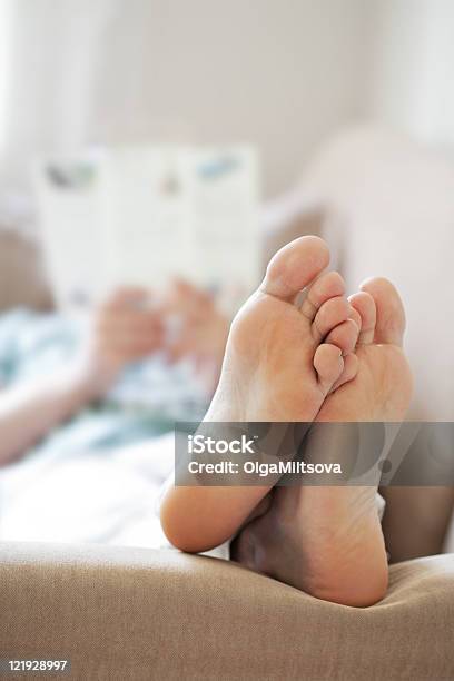 Man Relaxing On Sofa Stock Photo - Download Image Now - Adult, Adults Only, Bed - Furniture