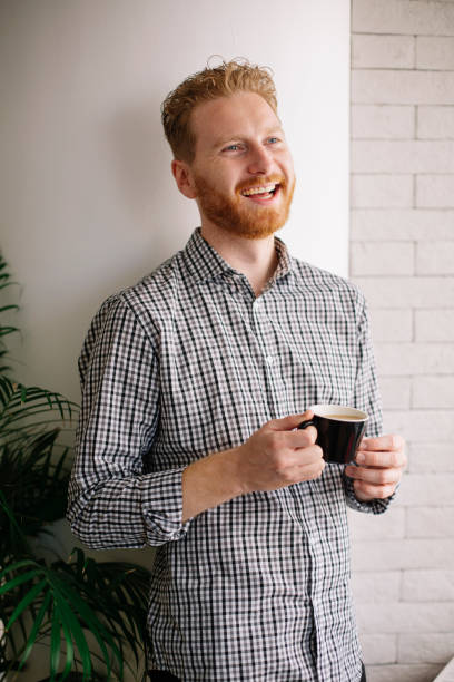 istock Young businessman drinking coffee in office. 1219291331