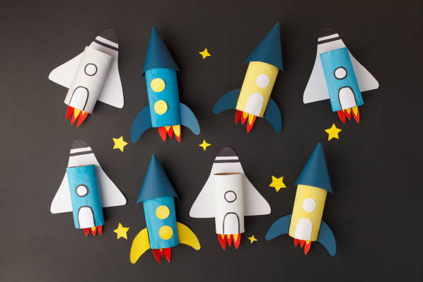 istock Set of spaceship, shuttle, rocket on black background with copy space for text. Concept of business launch, start up, handcraft, diy, creative idea from toilet tube, recycle 1219291974