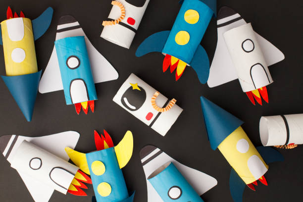 istock School kindergarten crafts, paper spaceship, shuttle, astronaut on black background with copy space for text. Party concept handcraft, diy, creative idea from toilet tube, recycle 1219291978
