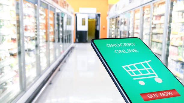 istock Smartphone mobile with grocery online on screen with blur supermarket background. 1219294065