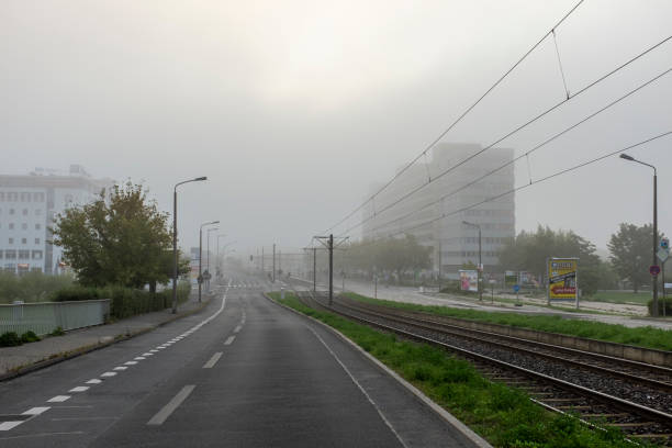 Berlin, Germany - September 14, 2013: View along Allee der Kosmonauten on a foggy morning, Berlin, Germany