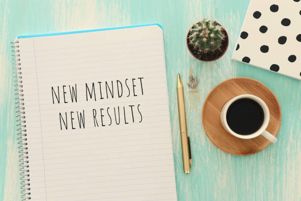 istock top view image of table with open notebook and the text new mindset new results. success and personal development concept 1219298335