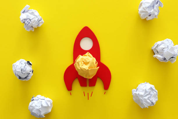 istock education or innovation concept. Wooden rocket over yellow background 1219298340