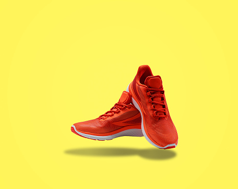 orange sneakers sport footwear for training shopping yellow background