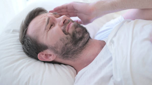 istock Sleepless Beard Young Man having Headache in Bed 1219301759