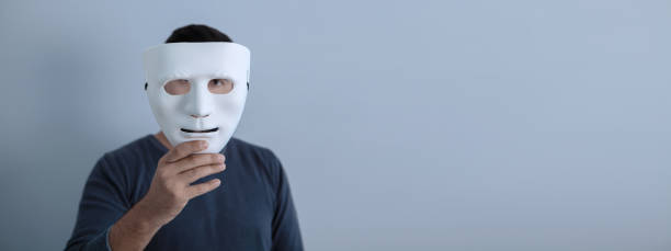 istock man covers his face with a white mask 1219302491