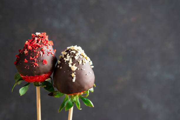 istock Strawberries in chocolate with dried berries on sticks, dark background. Copy space. 1219302688