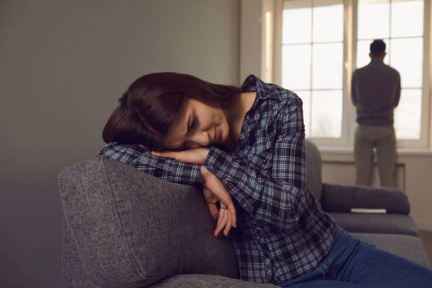 istock A young couple quarreling while sitting on a sofa in a room. 1219302691