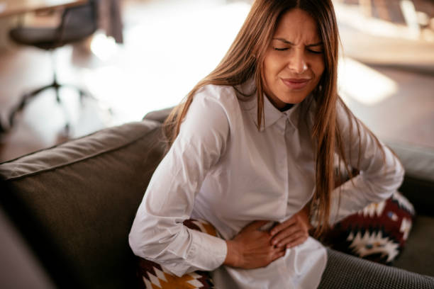 istock Woman with a stomach ache 1219302783