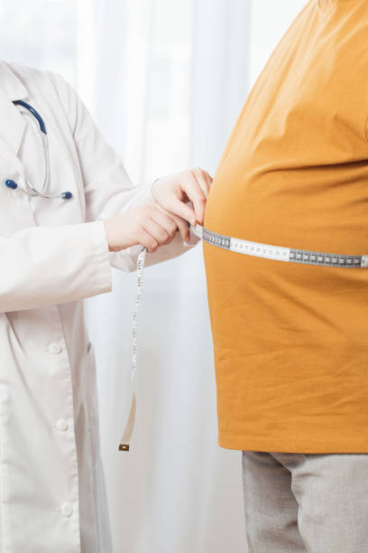 istock doctor measures  man measures  waist 1219304581