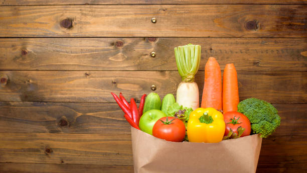 istock vegetables in grocery bag on wood background 1219304789