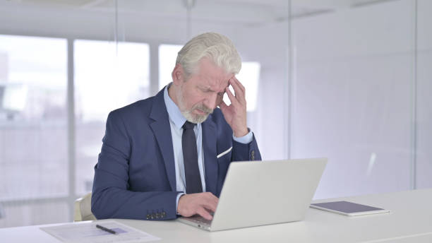 istock Tired Old Businessman having Headache 1219305001