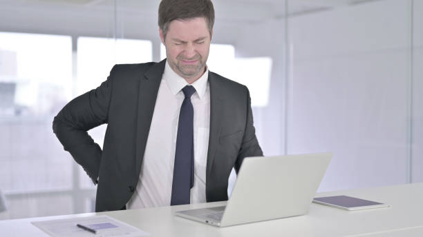 istock Tired Middle Aged Businessman having Back Pain 1219306261