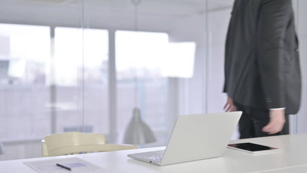 istock Attractive Middle Aged Businessman Standing up and Going Away 1219306277