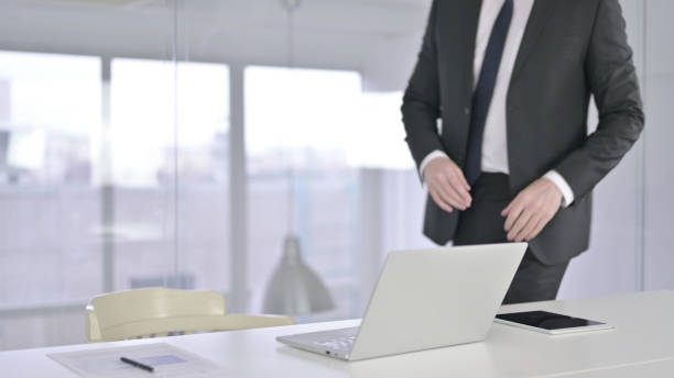 istock Middle Aged Professional Businessman Coming in and Sitting 1219306283