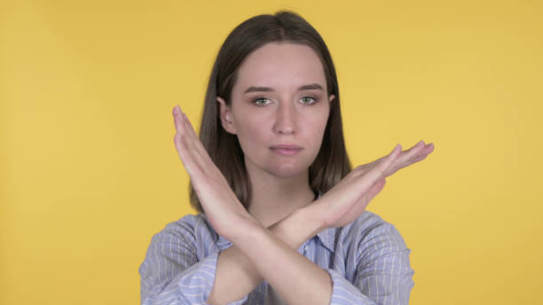 istock Disliking Young Woman Refusing on Yellow Background 1219306488