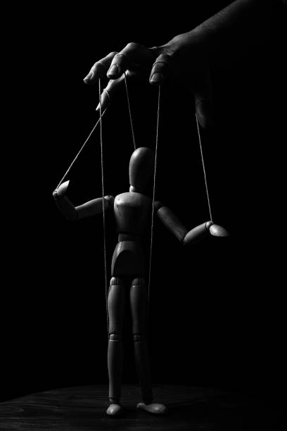 Conceptual image of a hand with strings on fingers to control a marionette in monochrome - fotografia de stock