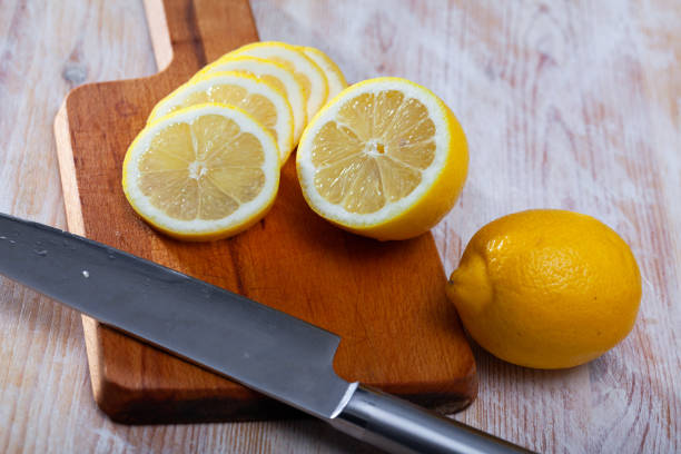 istock Sliced lemon on wooden table 1219307874