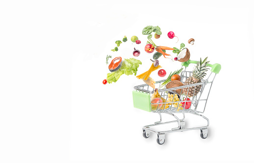 Shopping cart with different food products isolated on white background