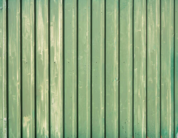 istock Old corrugated iron green paint background 1219309179