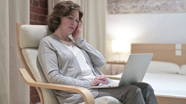istock Hardworking Old Woman having Headache on Sofa 1219309723