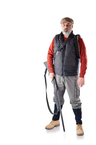 istock A man with a gray beard with a bag and a gun. 1219310311