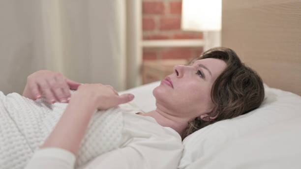 istock Scared Old Woman Waking up from Sleep 1219310339