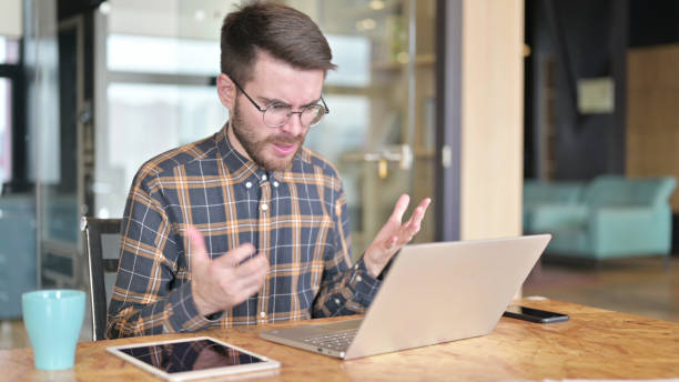 istock Young Designer getting Angry by Results on Laptop 1219310975