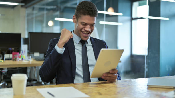 istock Young African Businessman using Tablet in Modern Office 1219311906