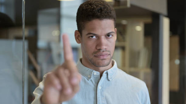 istock Young African Man Saying No with Finger Sign 1219312007