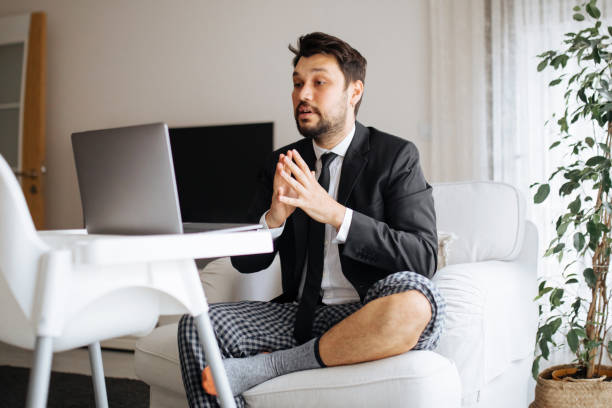 Having a productive day Young businessman at home pyjamas stock pictures, royalty-free photos & images