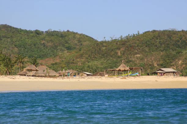 istock Touristic indonesian huts on beach in Kuta Lombok 1219314779