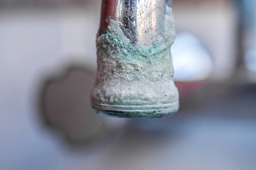 Calcification of a faucet closeup, faucet with lime deposit calcified detail