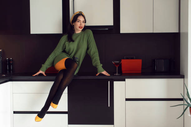 istock Pretty young fashionable brunette in a home studio 1219325563