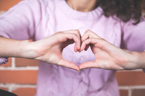 istock woman hand heart sign 1219326469