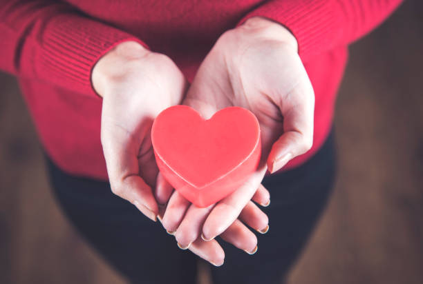 istock woman hand red heart 1219326669