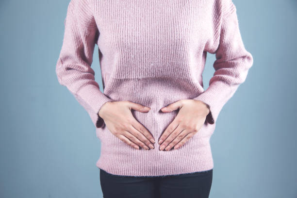 istock woman hand in ache ovaries 1219326695