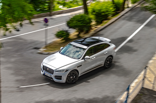 Rijeka, Croatia - July 12, 2016: A man is driving new Jaguar F-Pace fast on a country road. Jaguar F-Pace is the first Sport Utility Vehicle (SUV) made by famous British sports brand Jaguar.