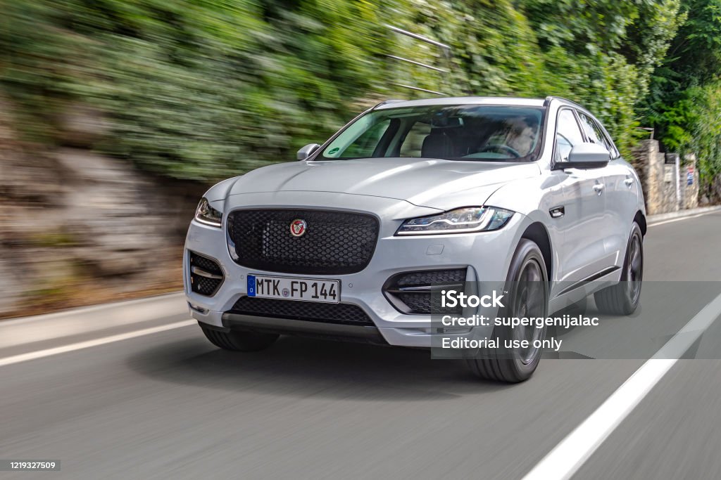 Jaguar F-Pace Rijeka, Croatia - July 12, 2016: A man is driving new Jaguar F-Pace fast on a country road. Jaguar F-Pace is the first Sport Utility Vehicle (SUV) made by famous British sports brand Jaguar. Jaguar Car Stock Photo