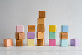 The wooden cubes are multicolored and natural. Children's cubes