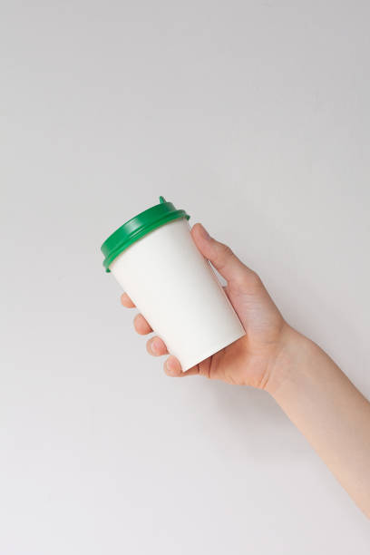 istock Take away coffee cup background. Male hand holding a coffee paper cup 1219328864