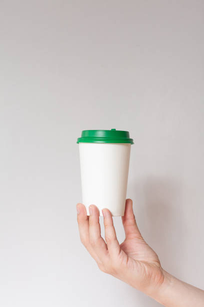 istock Take away coffee cup background. Male hand holding a coffee paper cup 1219328875