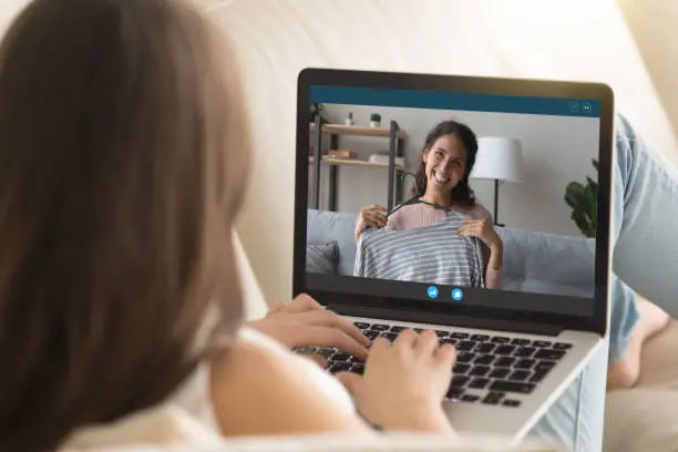 Photo of Young woman relax talk on video call with friend