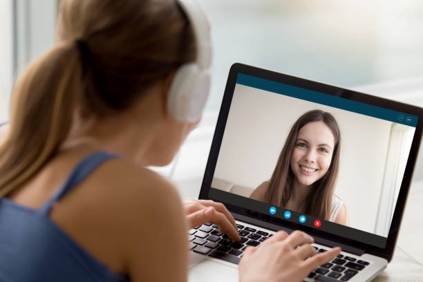 istock Young female speak on video call with friend 1219329132