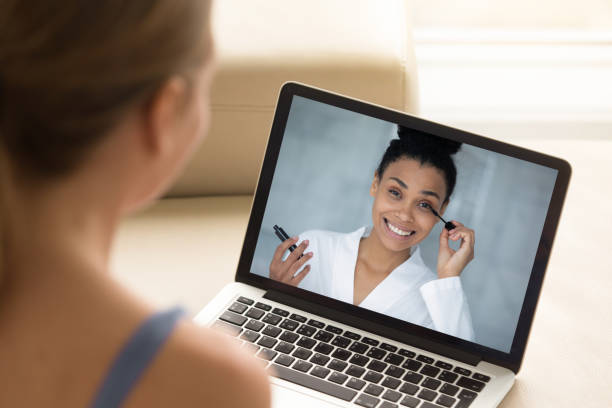 Young woman watch online makeup tutorial on laptop