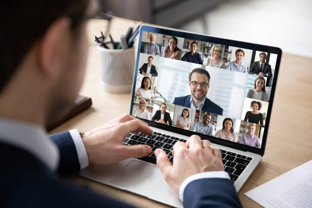 istock Back view of employee have online web conference with colleagues 1219329138