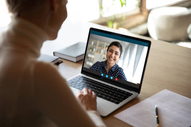 istock Female employee communicate talk online with indian coworker 1219329148