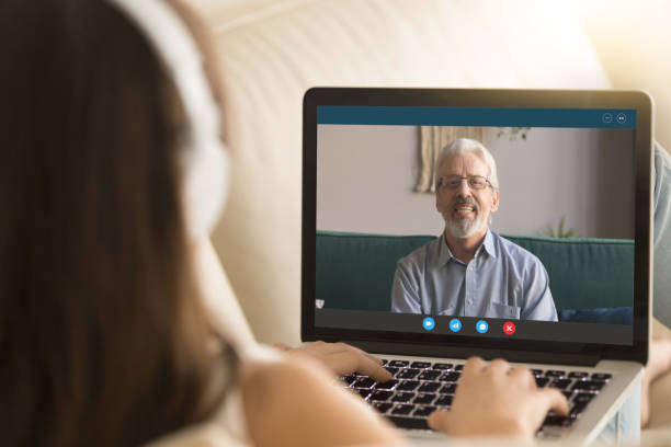 istock Young girl talk with senior dad on video call 1219329151