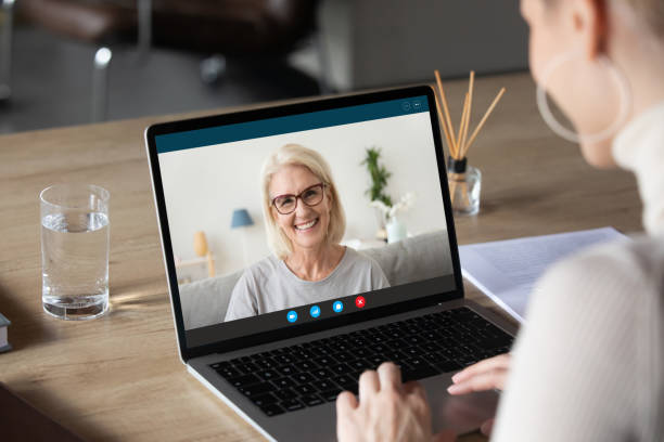 istock Young female speak on video call with mature mom 1219329153